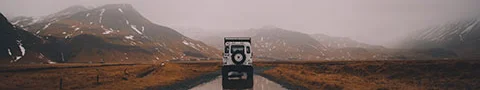 A car reflected in a soaked gravel road